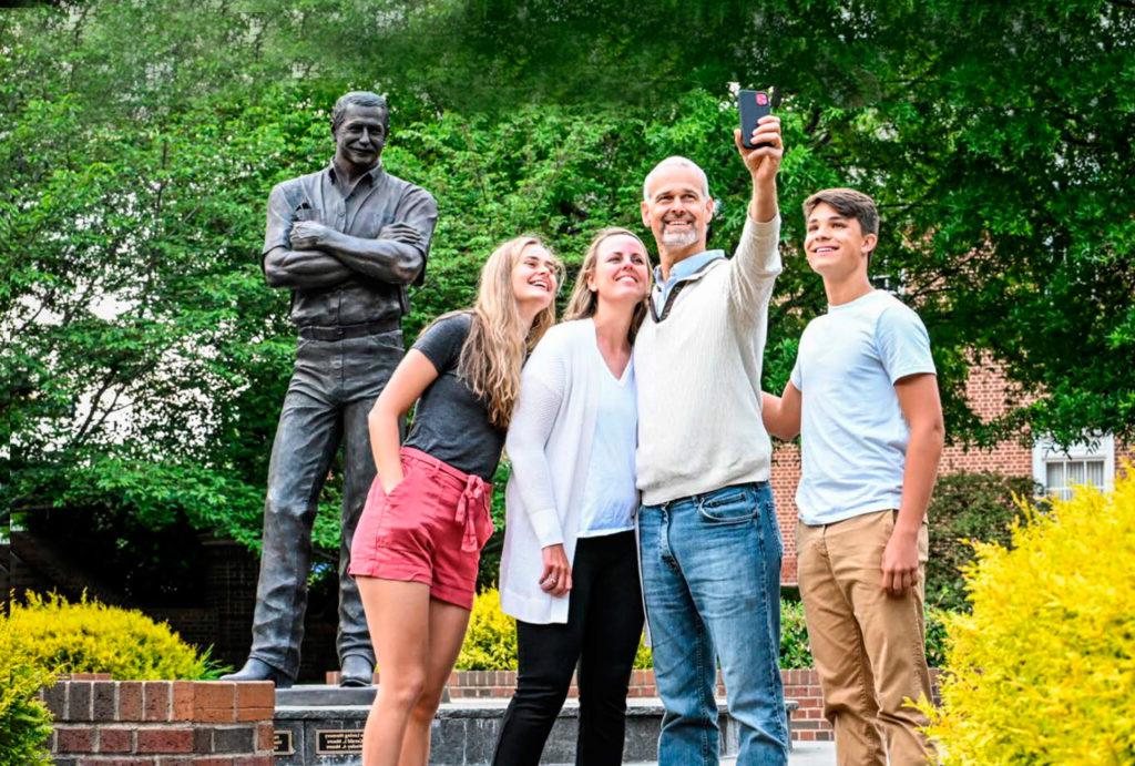 family poses in front dale earnhardt statue